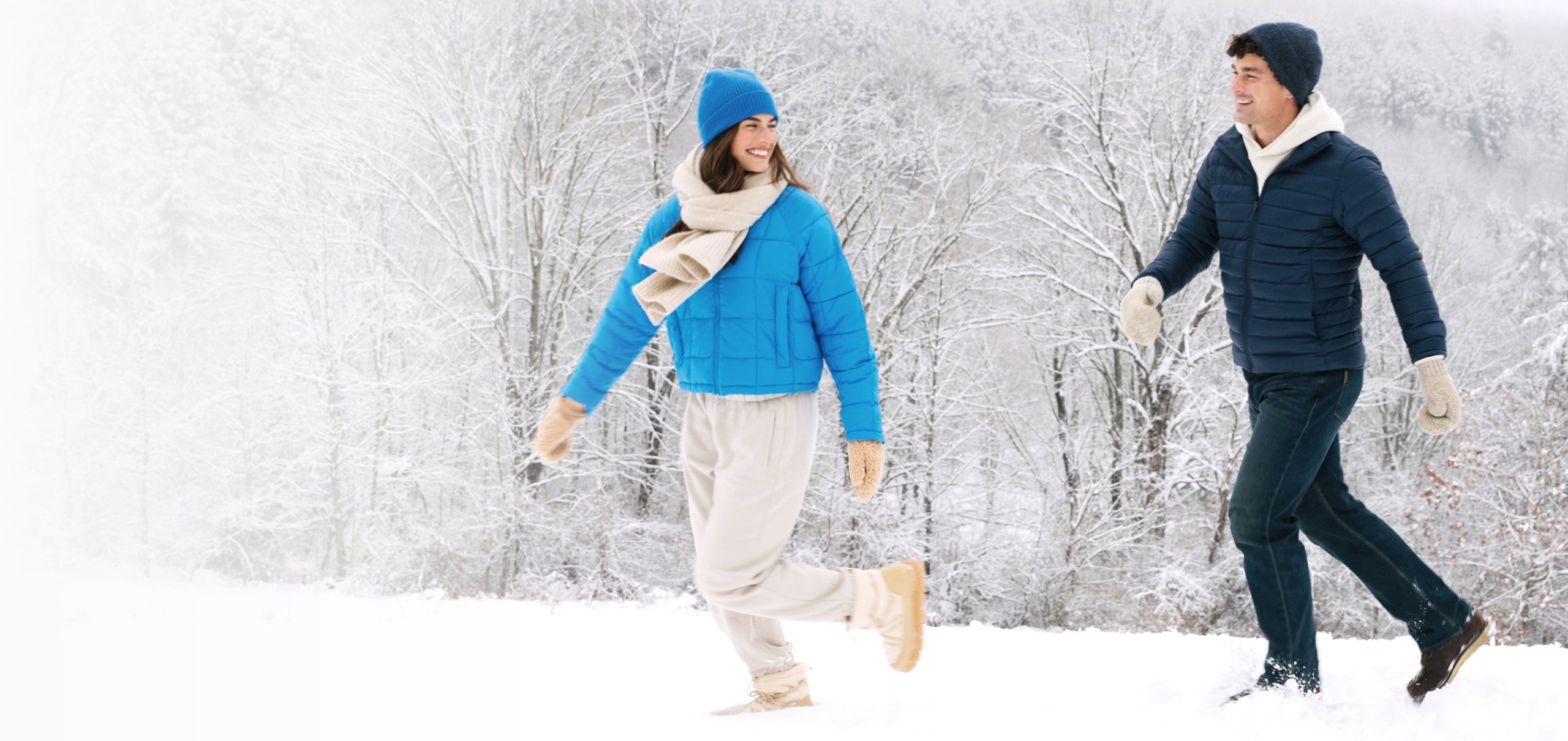 Two people walking on a snowy hill