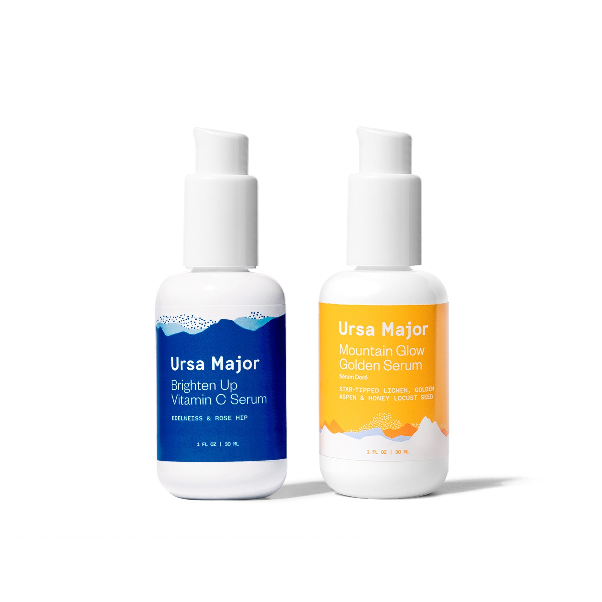 Bottles of Ursa Major Brighten Up Vitamin C Serum and Mountain Glow Golden Serum on a white background.