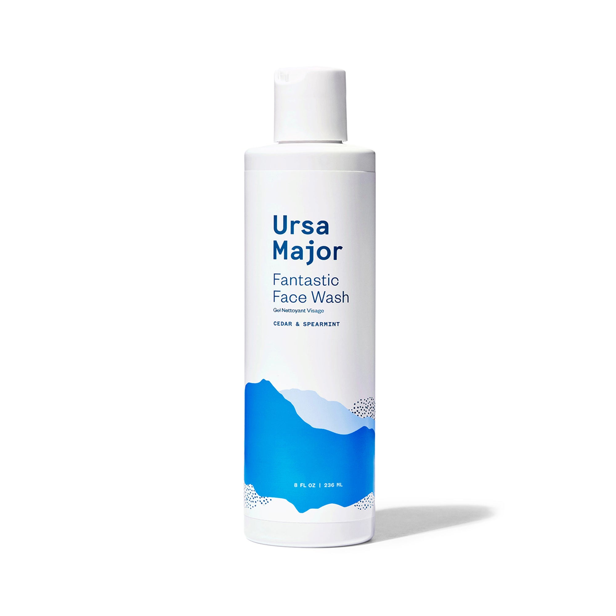 Bottle of Ursa Major Fantastic Face Wash. Bottle is white is dark-blue lettering and blue mountains.