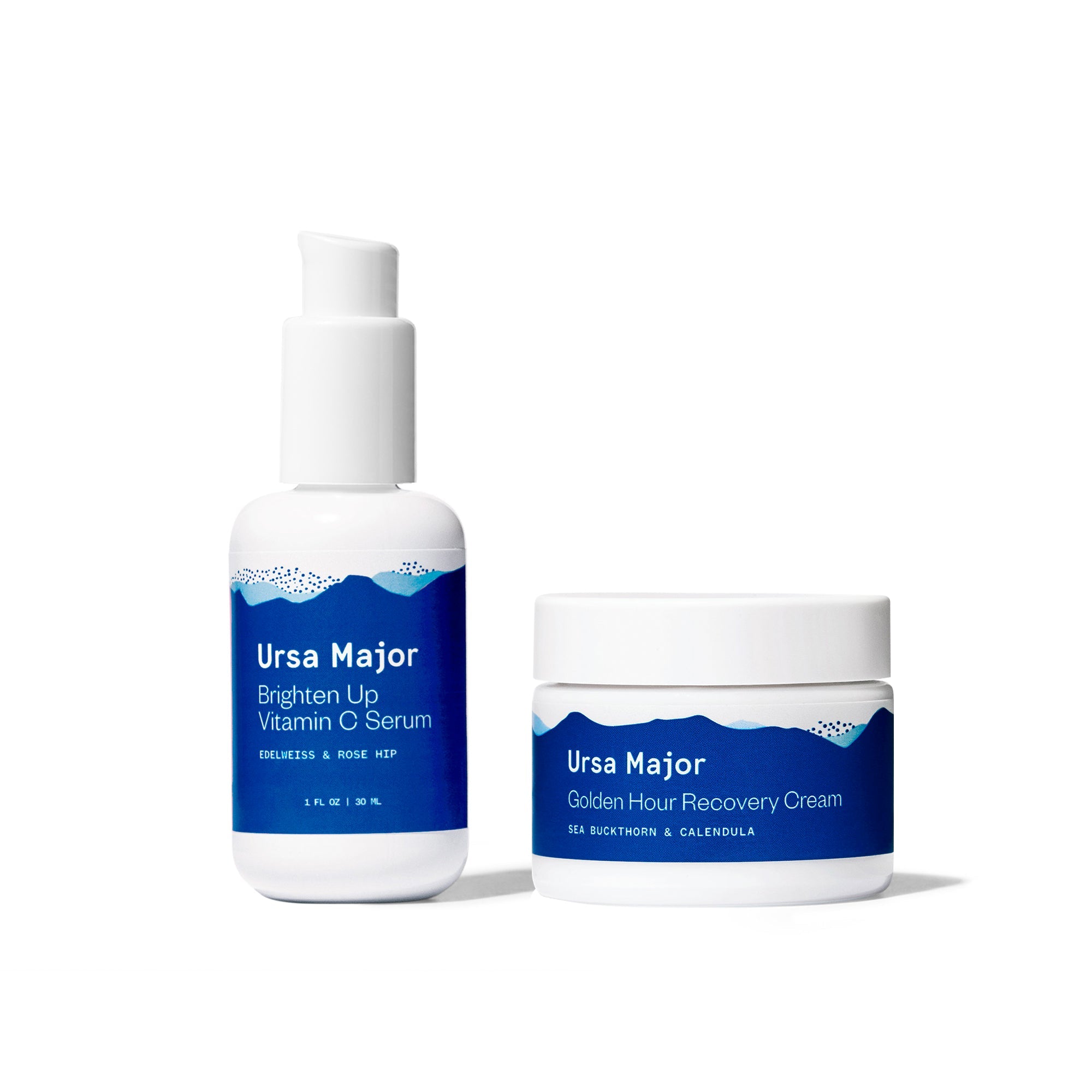 Bottle Of Ursa Major brighten Up Vitamin C Serum next to a jar or Golden Hour Recovery Cream on a white background.