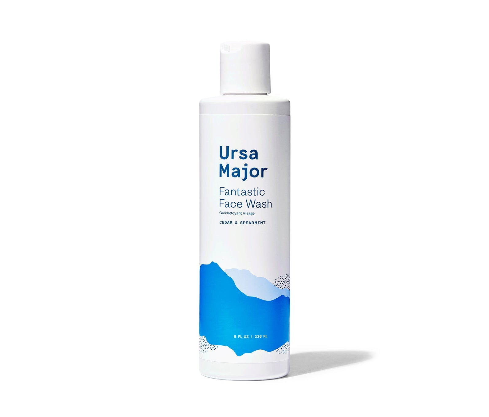 Bottle of Ursa Major Fantastic Face Wash. Bottle is white is dark-blue lettering and blue mountains.