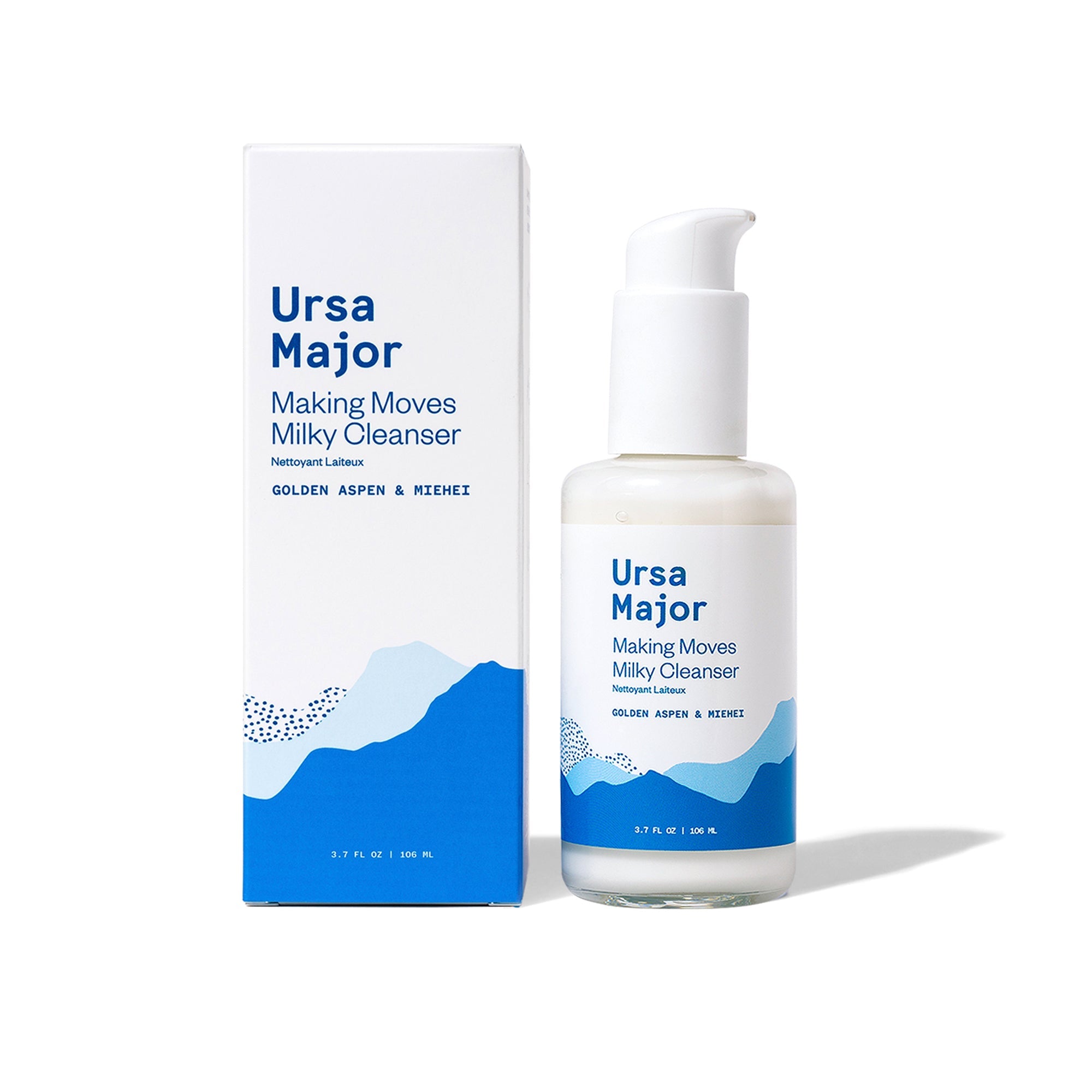 Box of Ursa Major Making Milky Cleanser next to the bottle on a white background.  Box and jar are white with blue lettering and blue mountains.