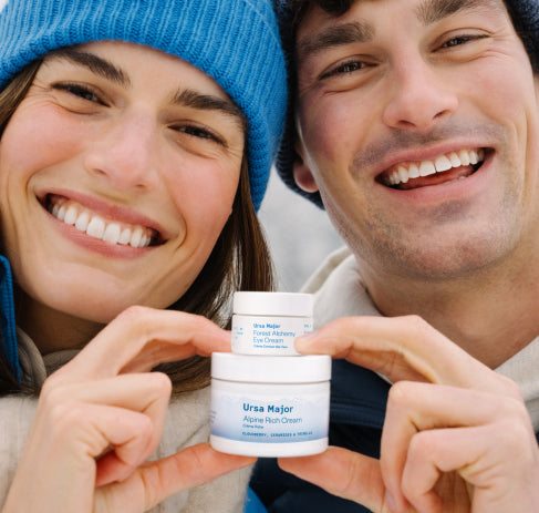 A woman and man holding two products outside